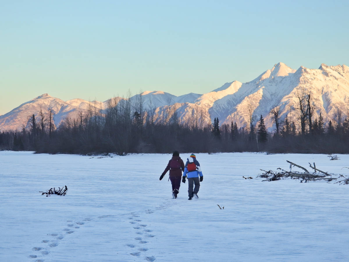 Taylor Family walking on frozen Knik River during winter kayak tour with Adventures by True North Alaska Palmer Alaska 1
