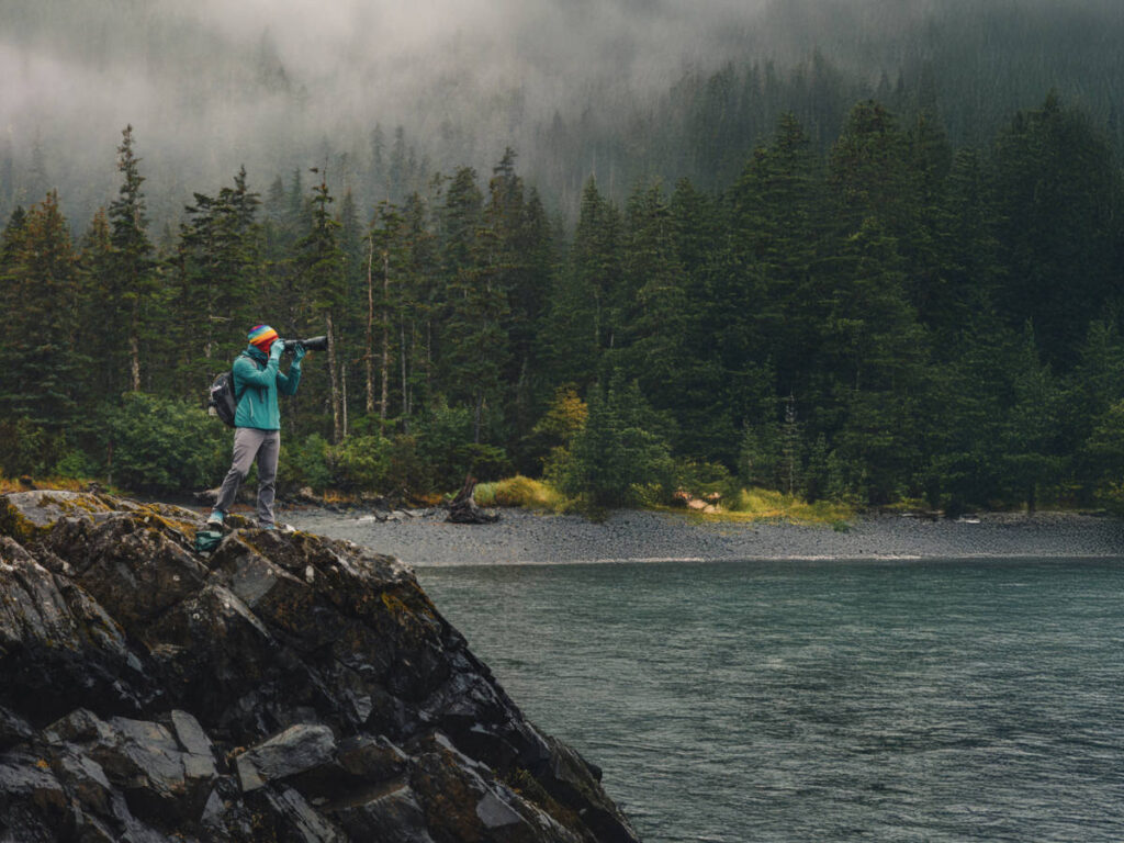 Rob Taylor taking photos on rock with Lazy Otter Charters Whittier Alaska 1
