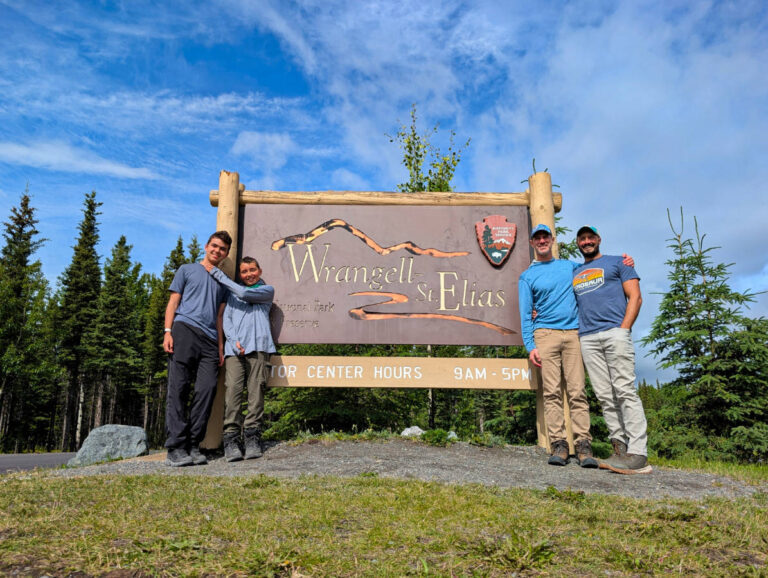 Full Taylor Family at Entrance Sign to Wrangell St Elias National Park Copper Center Alaska