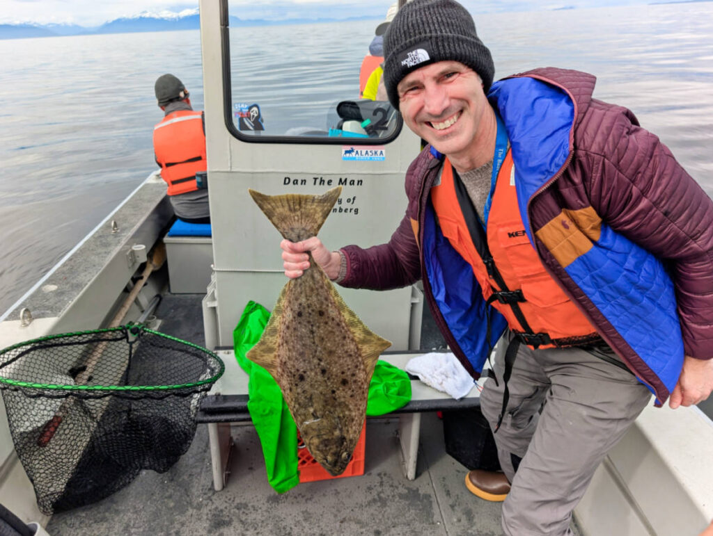 Chris Taylor catching halibut on Mist Cove Boat Company Southeast Alaska