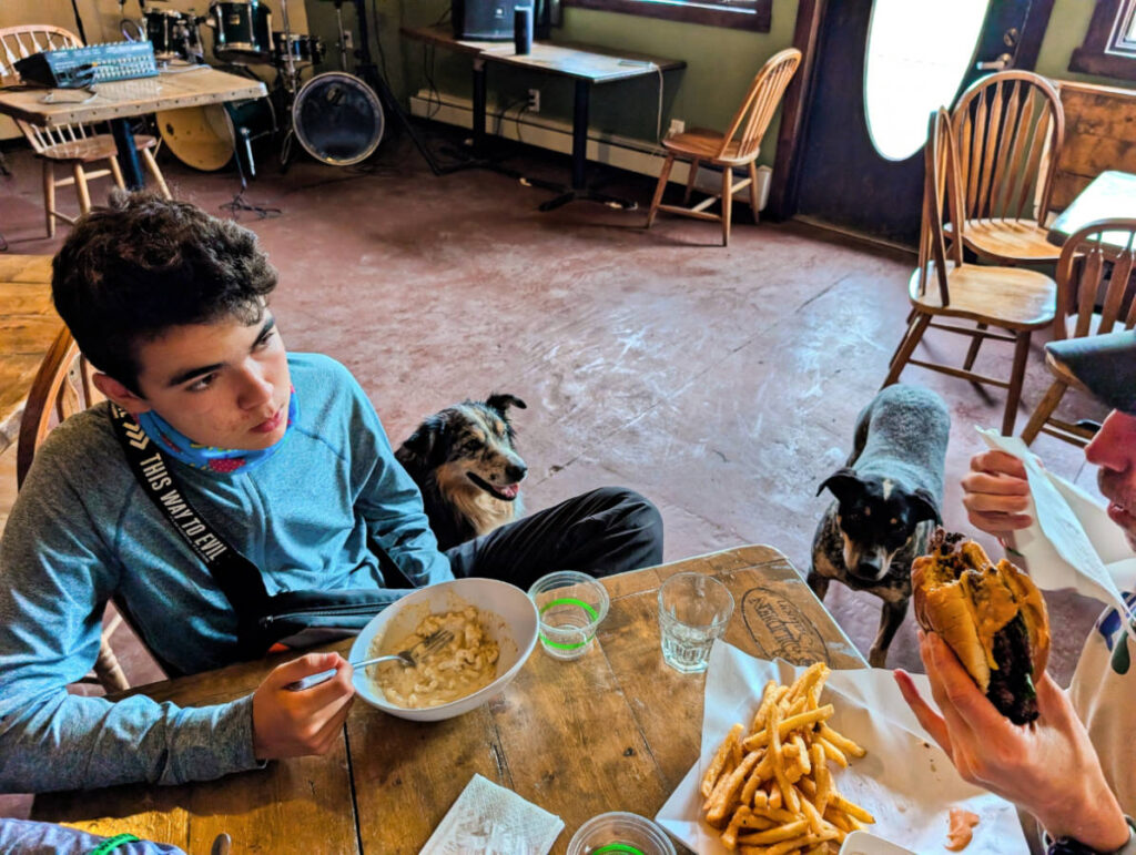 Taylor Family with Saloon Dogs in Golden Saloon McCarthy Lodge Resort Alaska