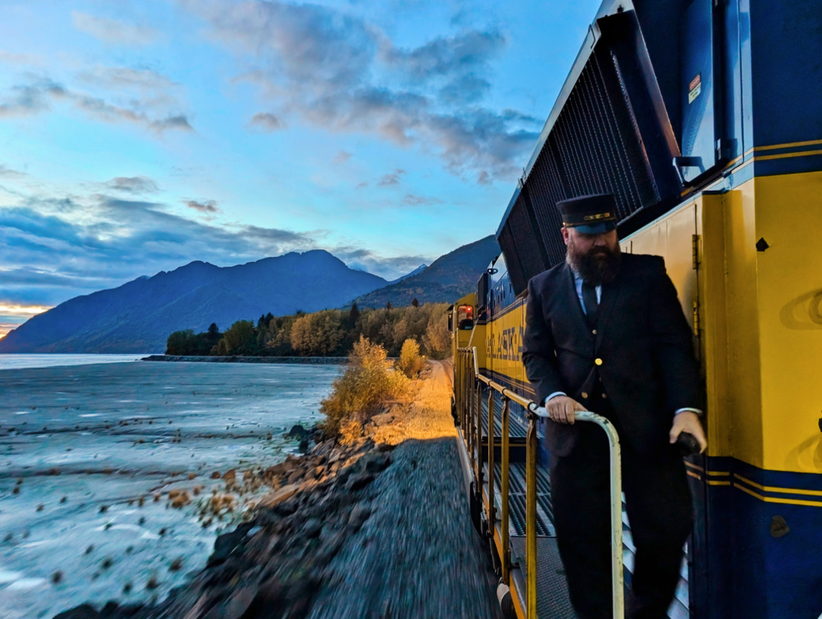 Train Conductor at Sunset on Alaska Railroad on Turnagain Arm Anchorage Area Alaska